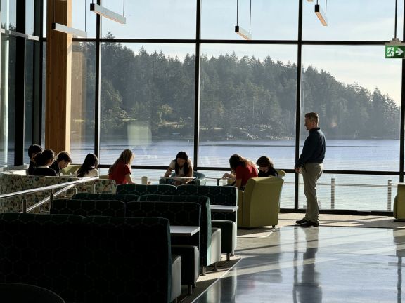 Study space surrounded by bright windows looking to ocean