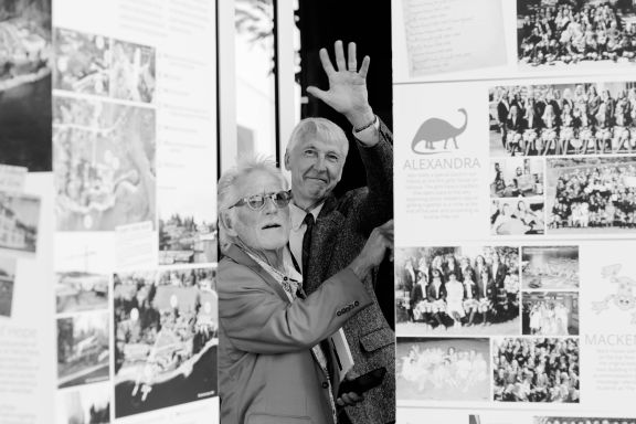 Two men viewing a history display about boarding houses over 100 years