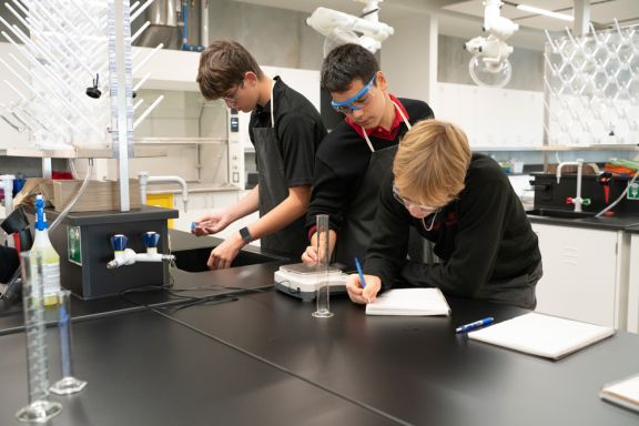 three private school students in chemistry lab