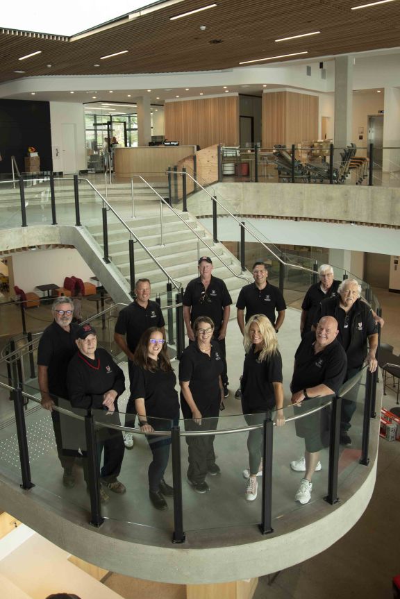 Brentwood Transportation Team group photo on staircase of new academic centre