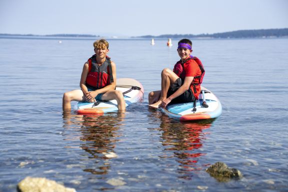 private school students on paddle boards