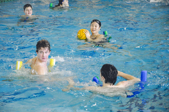 Students playing water polo in the pool