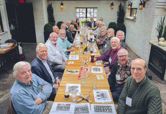 A group of older alumni having a lunch