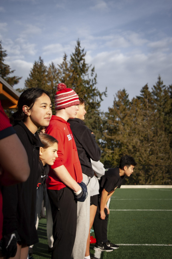 A group of students eagerly awaiting the start of a flag football game