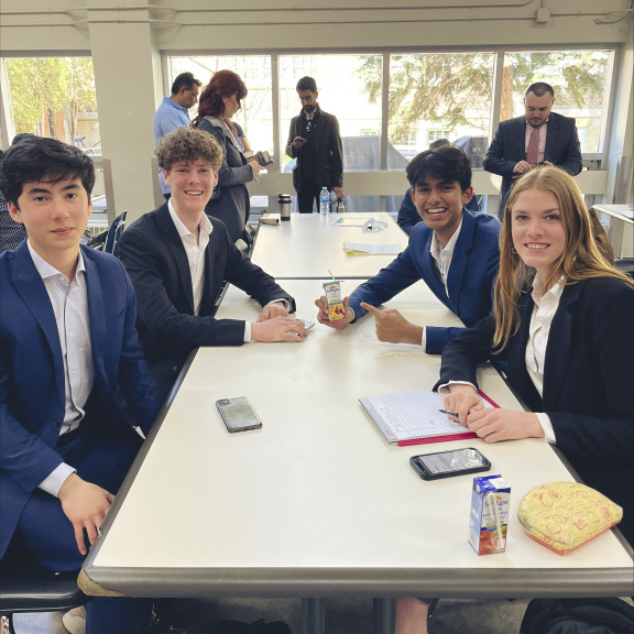 Four students having lunch at a debate competition