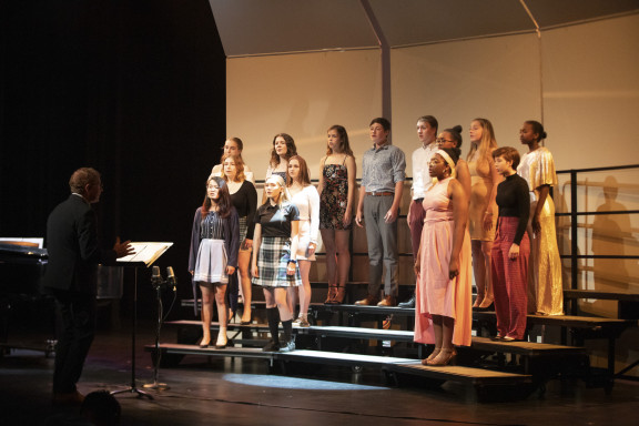 A choir of students singing on stage at Brentwood